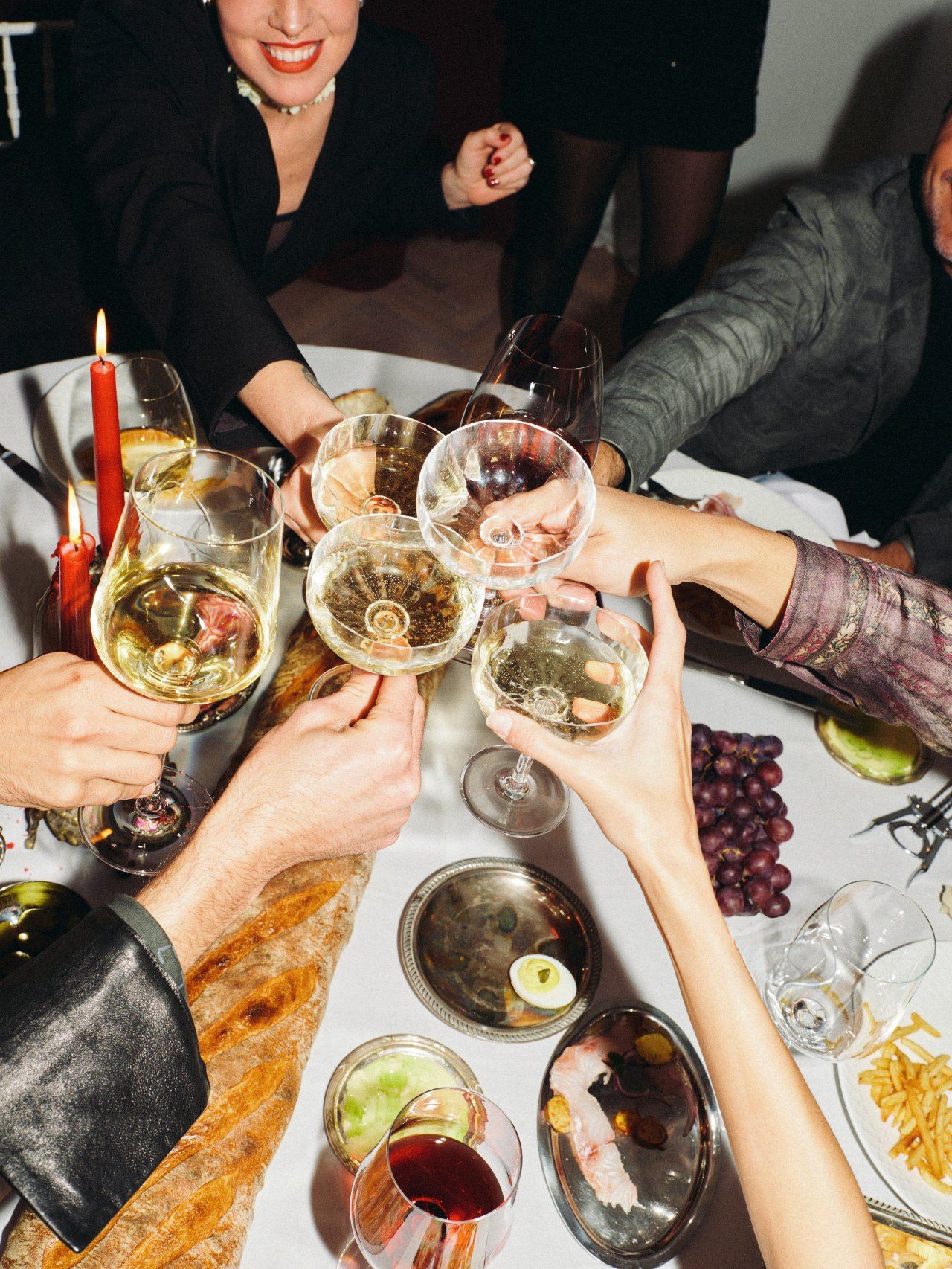 An evening table, glasses raised