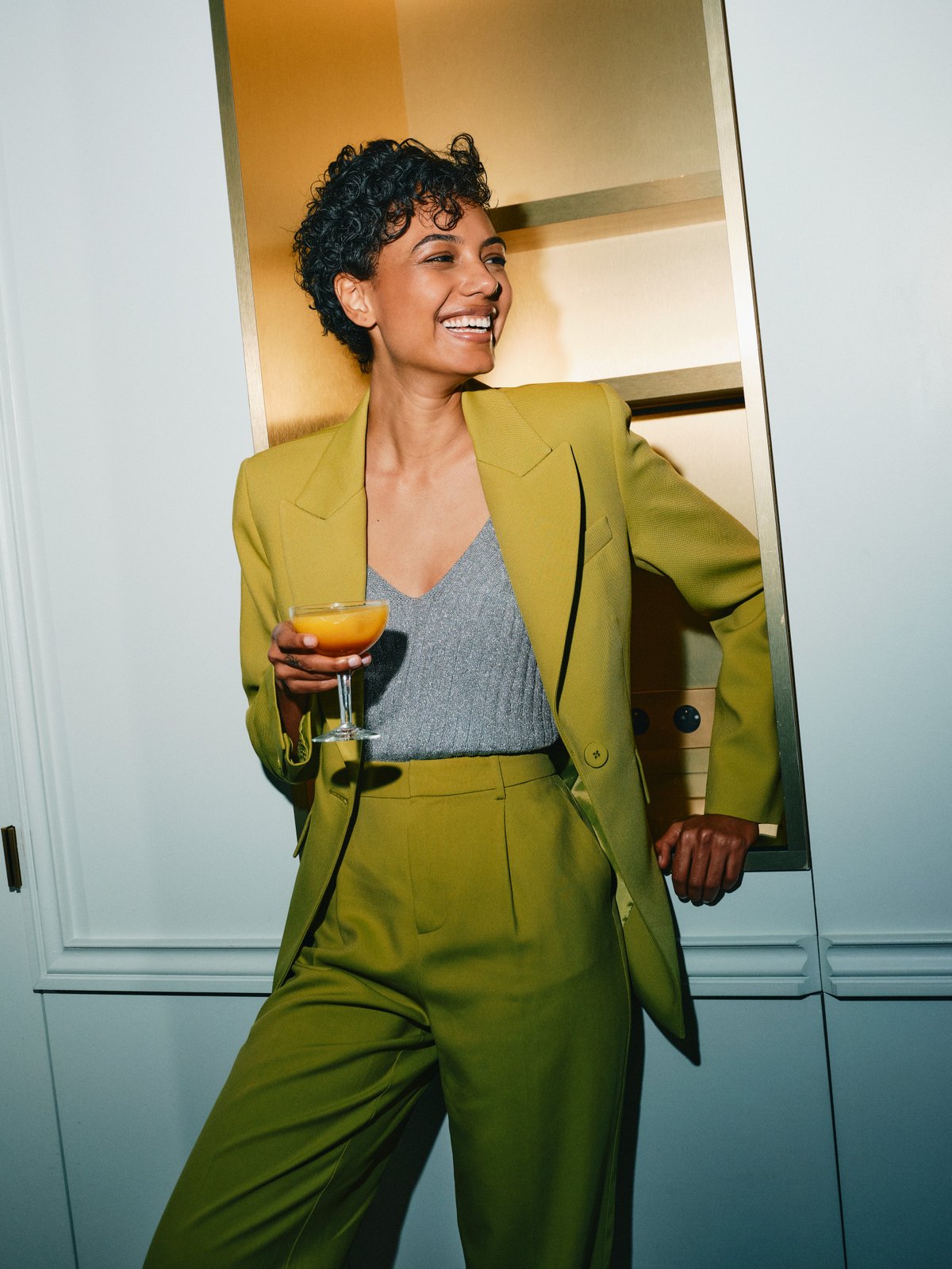 Someone mid-evening, drink in hand
